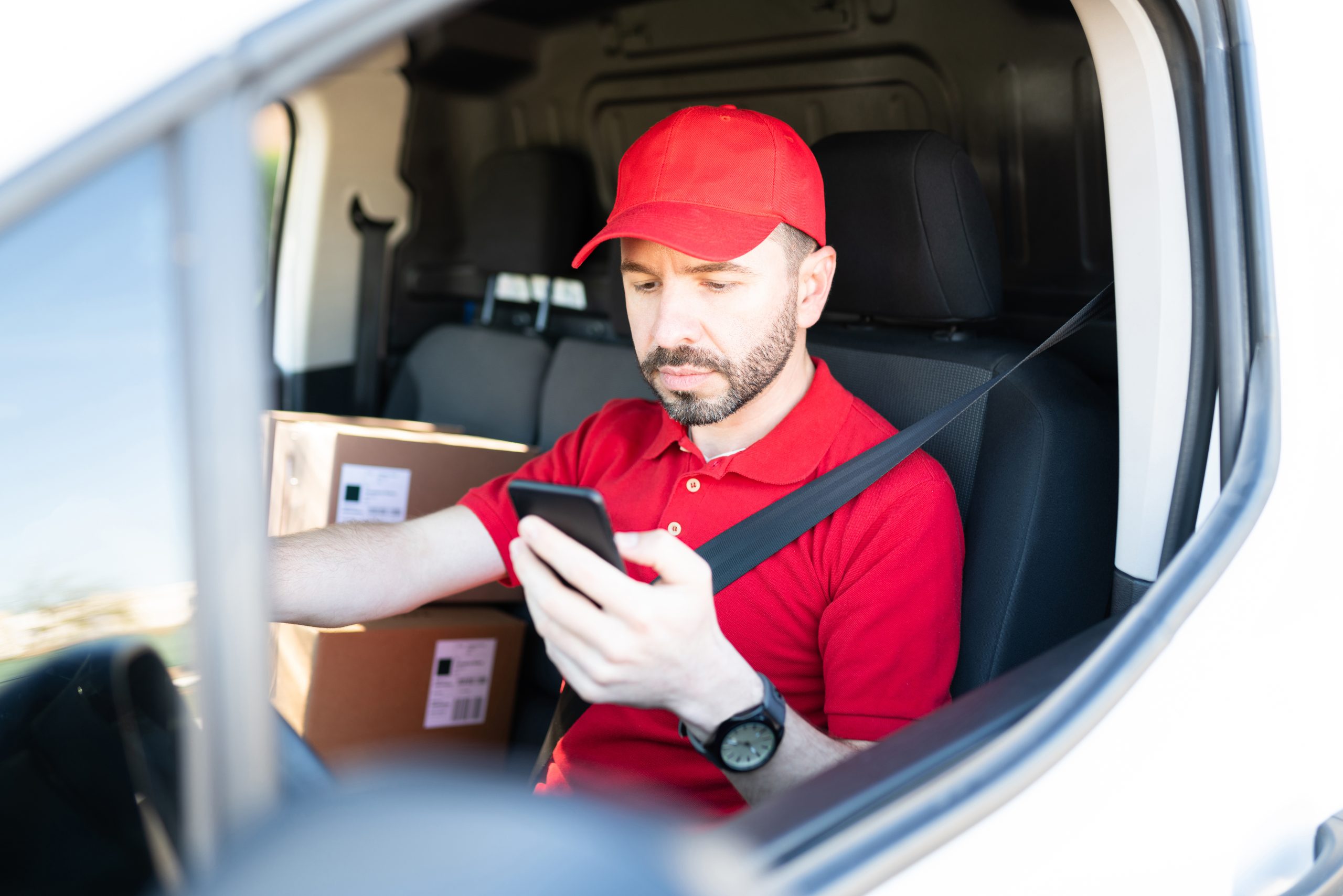 Delivery man using the navigation map on his smartphone could be considered a distracted driver.