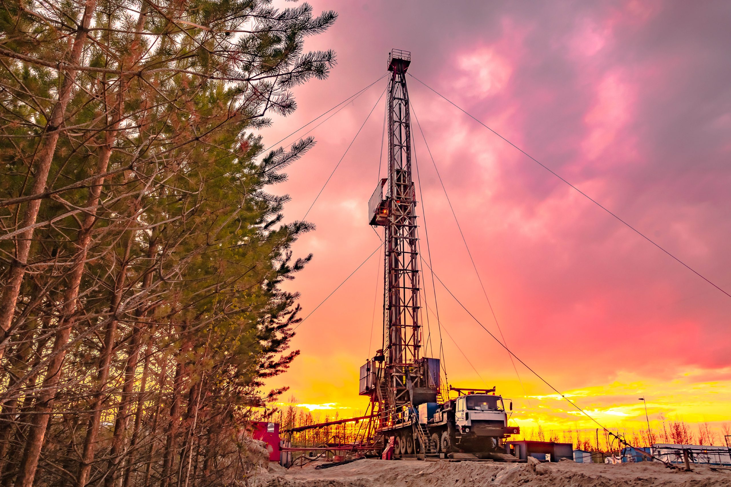Hydraulic Fracturing - Flowback: a drill site with a sunset in the background.