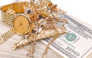 god and diamond watches/valuables on a stack of 100 dollar bills