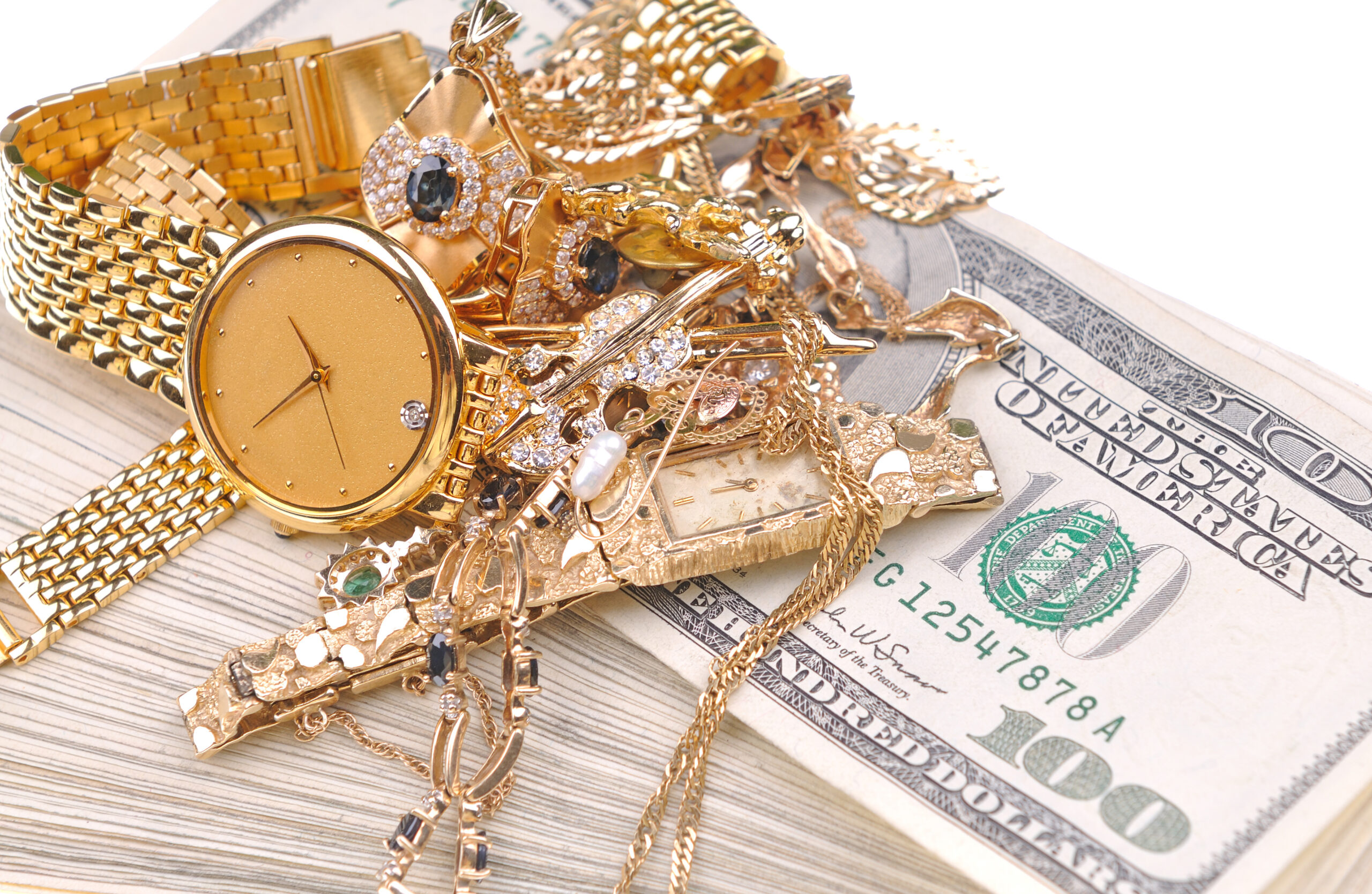 god and diamond watches/valuables on a stack of 100 dollar bills
