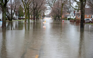 A flooded roadway in the Chicago area on a cloudy day.