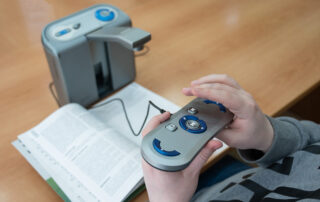 A visually impaired man uses a scanning and reading machine