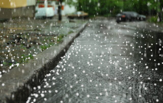 View of city street on rainy day with hail
