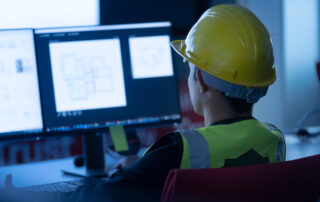 Industrial Engineering works in front of monitors, stressing the importance of a positive cybersecurity culture.