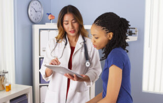 patient explaining issues to doctor using tablet