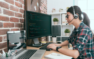 professional female computer engineer using data code fixing customer website and through online remote system monitoring.