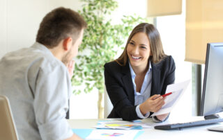 2024 Open Enrollment Preparation: Boss showing a good job congratulating an employee at office