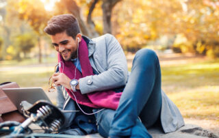 Working Remotely from Public Spaces: Young Businessman working remotely at public park