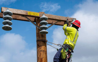 OSHA Expands Injury and Illness Submission Requirements in High-hazard Industries: worker doing maintenance on a power line.