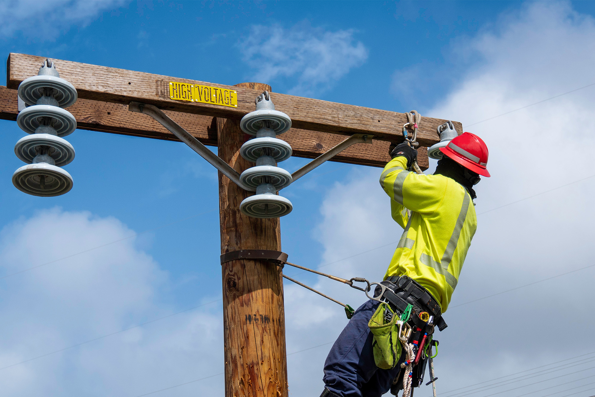 OSHA Expands Injury and Illness Submission Requirements in High-hazard Industries: worker doing maintenance on a power line.