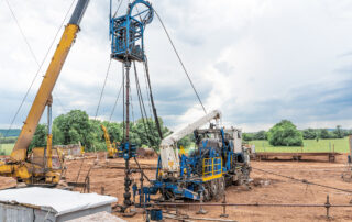 General Servicing Precautions for Wells: Coiled tubing unit doing well clean out. Wireline equipment hanging from top drive ready to be lowered downhole for logging.