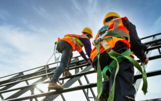 Top 4 Construction Hazards: Safety body construction, Working at height equipment. Fall arrestor device for worker with hooks for safety body harness on the roof structure