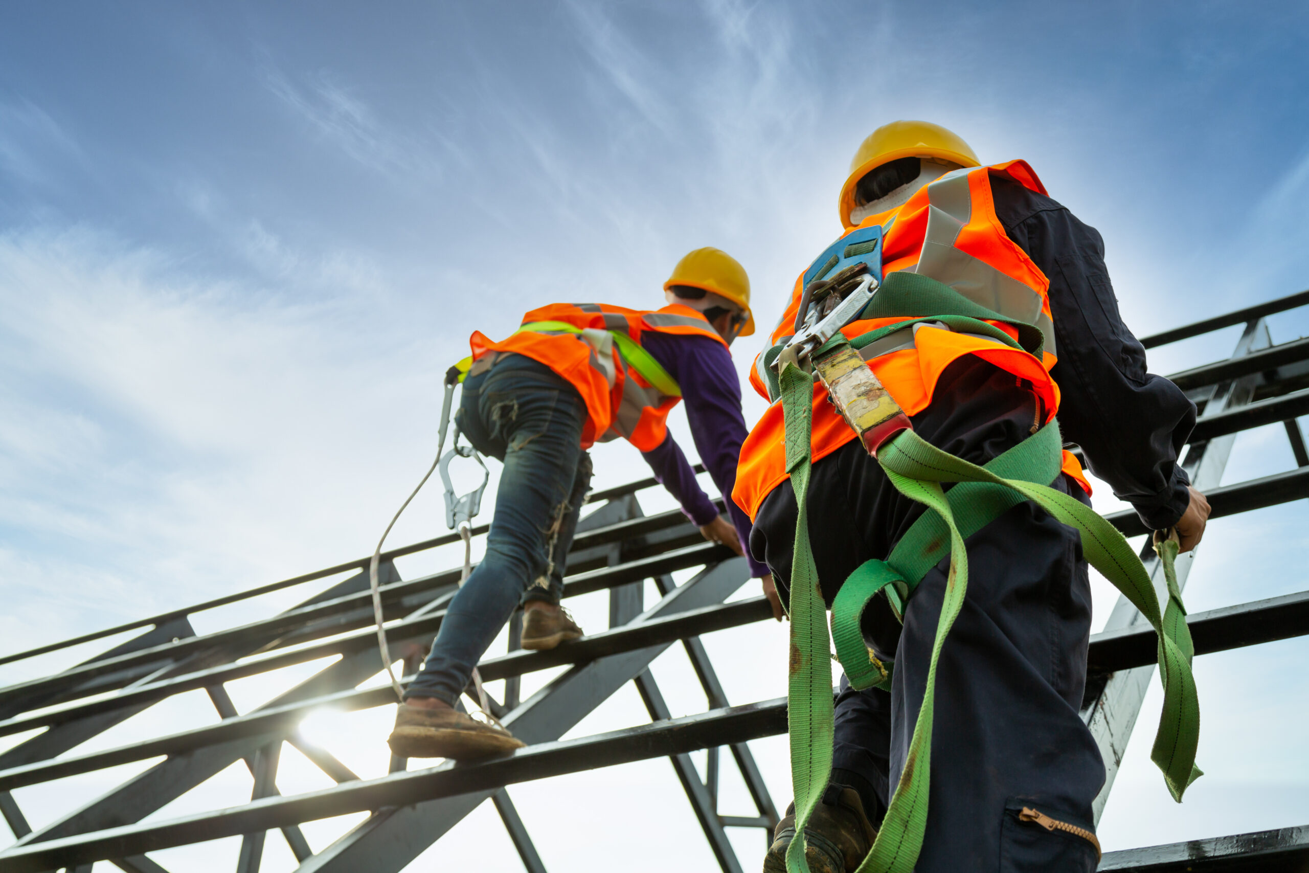 Top 4 Construction Hazards: Safety body construction, Working at height equipment. Fall arrestor device for worker with hooks for safety body harness on the roof structure