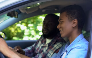 Teen Driver: A father and son sitting in the car.