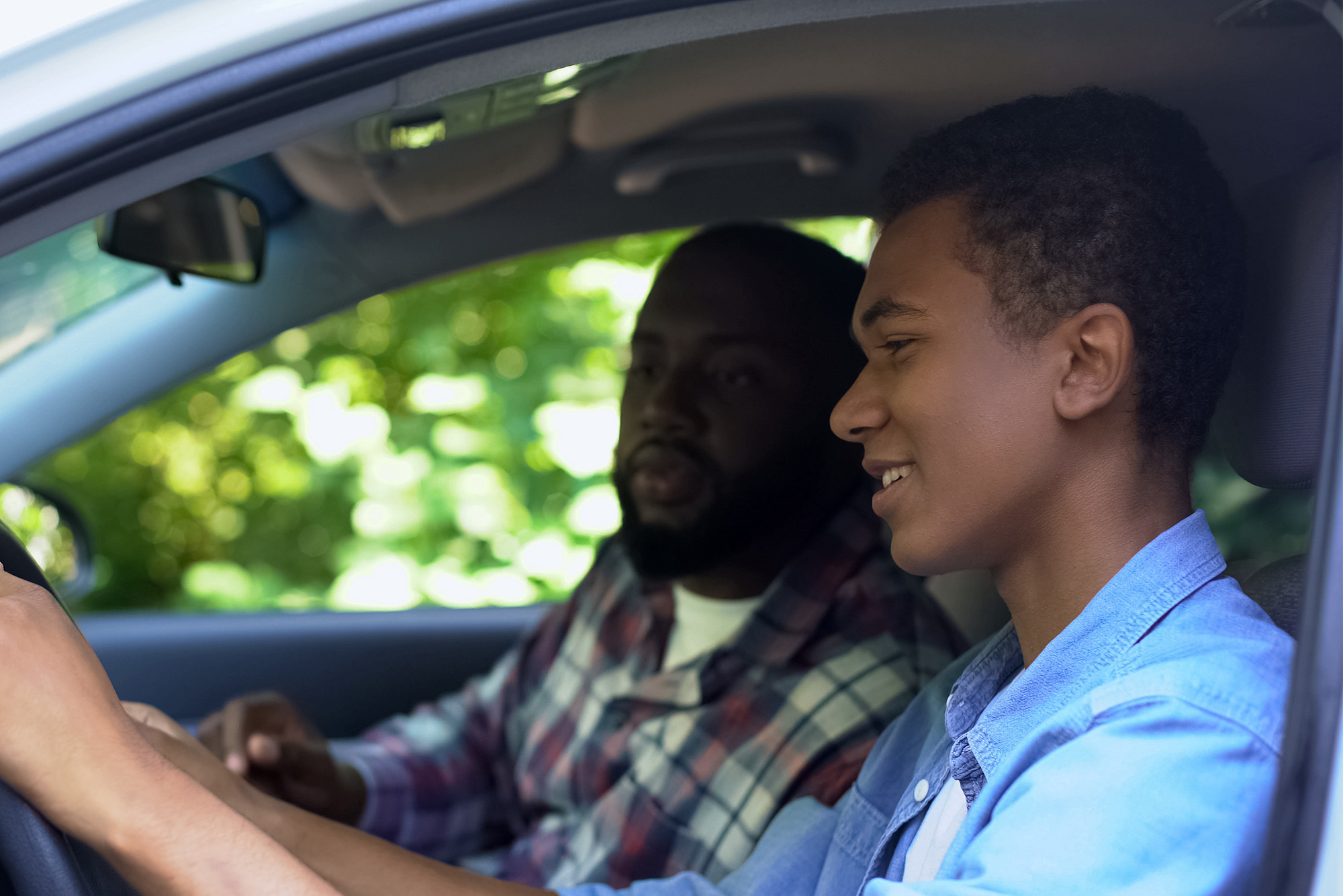 Teen Driver: A father and son sitting in the car.