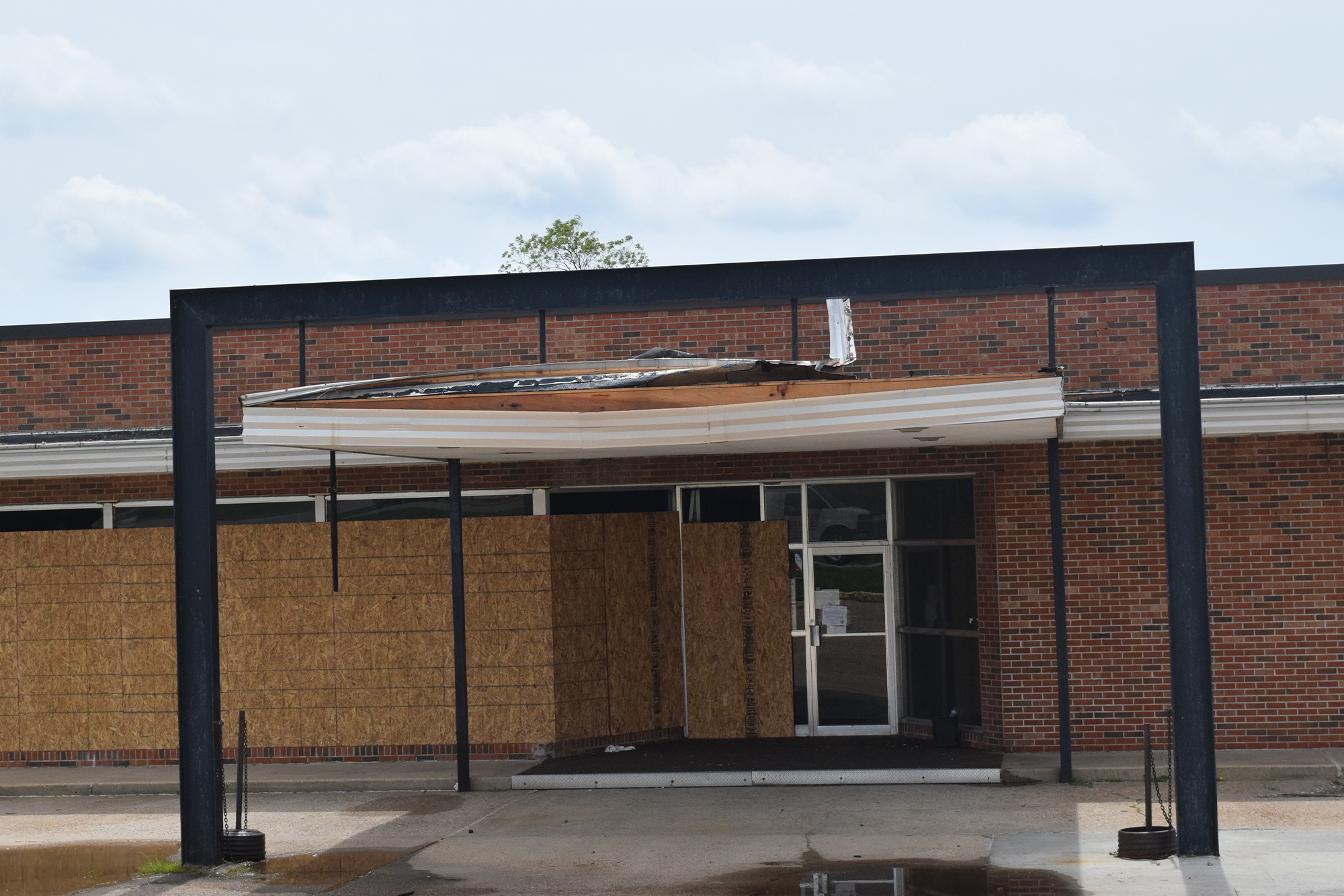 A storm damaged school building. with visible wind damage. 
