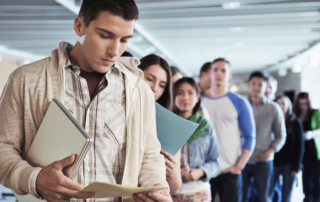 Support Your Staff as They Transition Back to Student Loan Payments: A line of young colleagues looking worried.