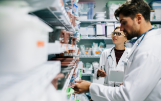 What the Transformation of PBM Could Mean for Employers: Two pharmacists checking inventory