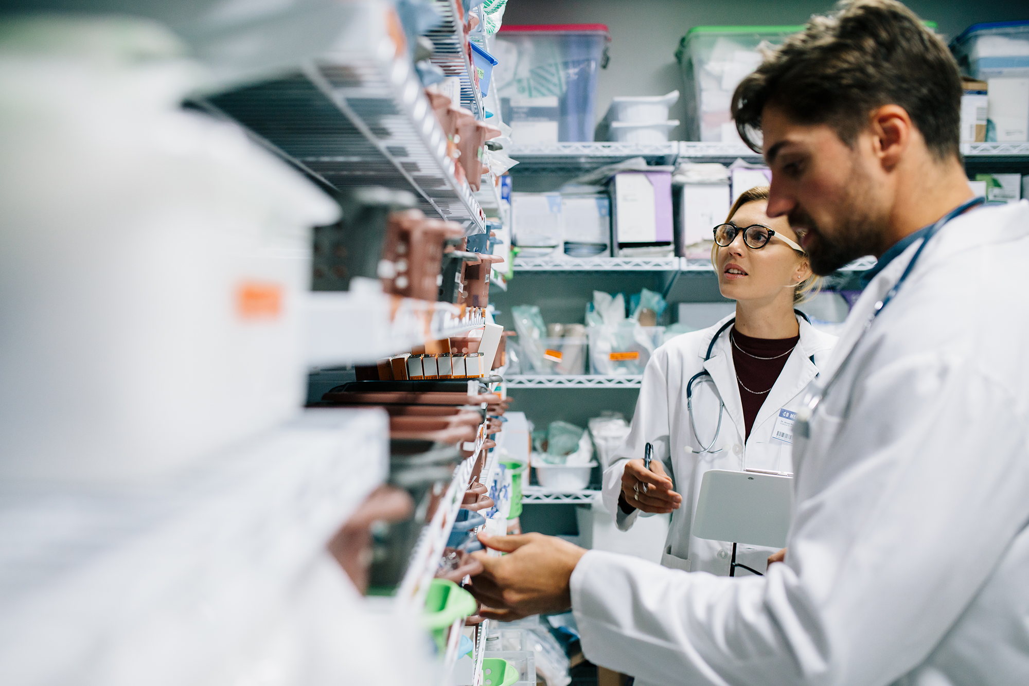 What the Transformation of PBM Could Mean for Employers: Two pharmacists checking inventory