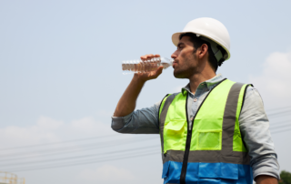 Heat Rules: OSHA’s National Emphasis Program (NEP) for Heat: A male construction worker drinking a bottle of water.