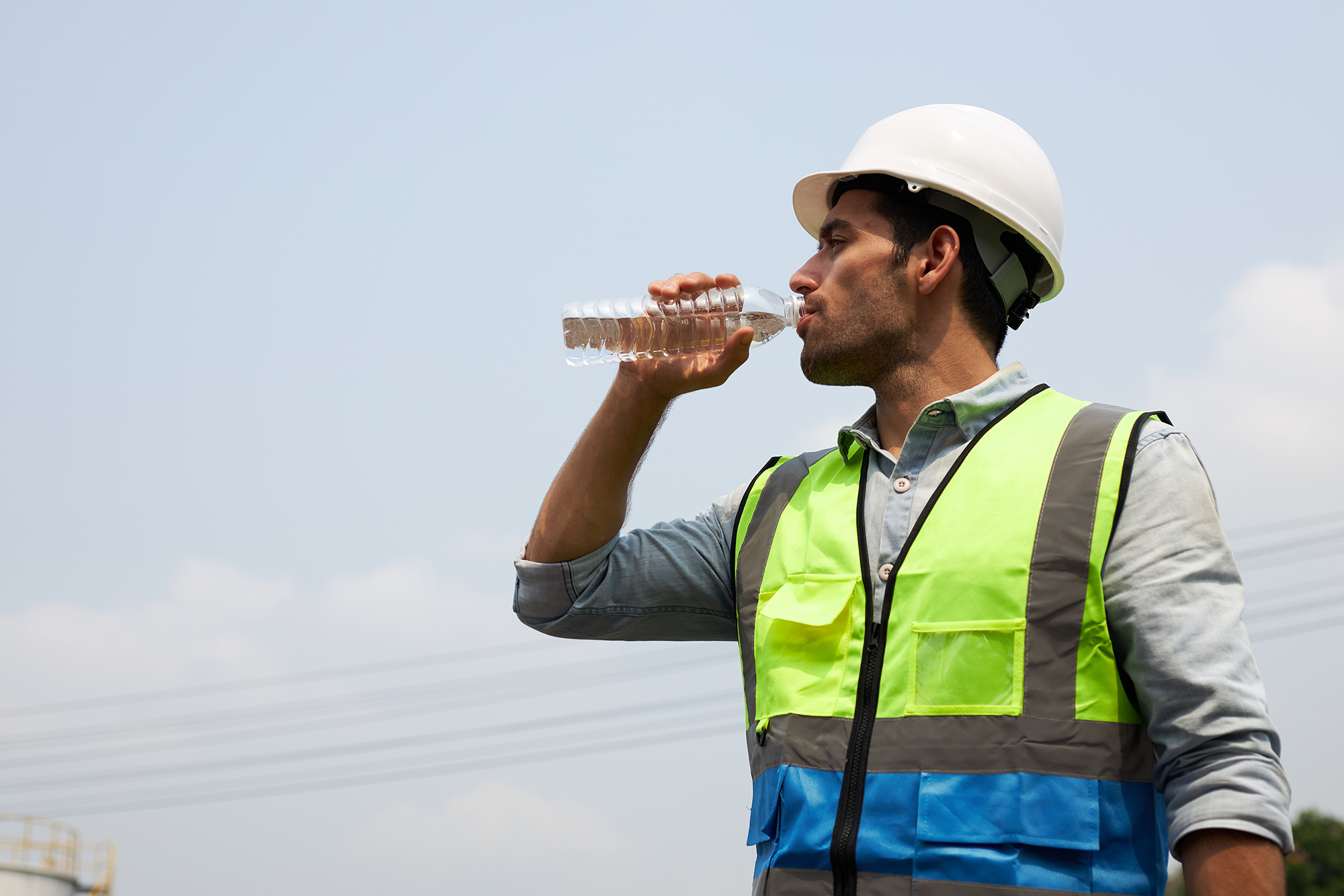 Heat Rules: OSHA’s National Emphasis Program (NEP) for Heat: A male construction worker drinking a bottle of water.