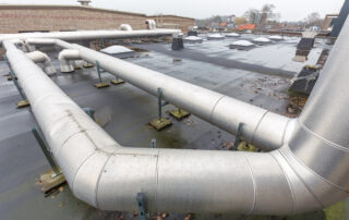 Metal pipes for ventilation system on flat roof of school