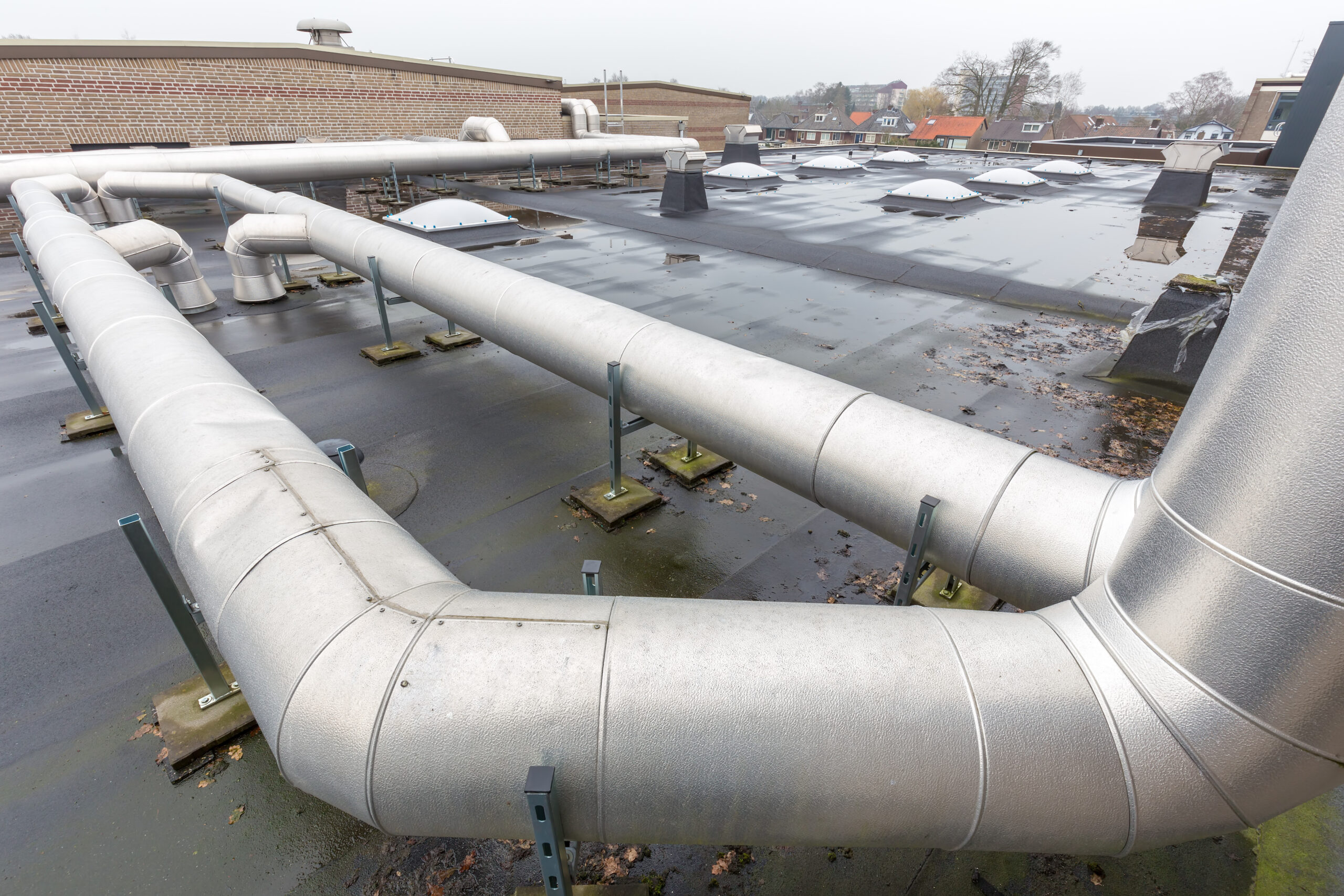 Metal pipes for ventilation system on flat roof of school