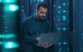 Cybersecurity Awareness Programs: Benefits and Implementation - a male IT professional working in a server room.