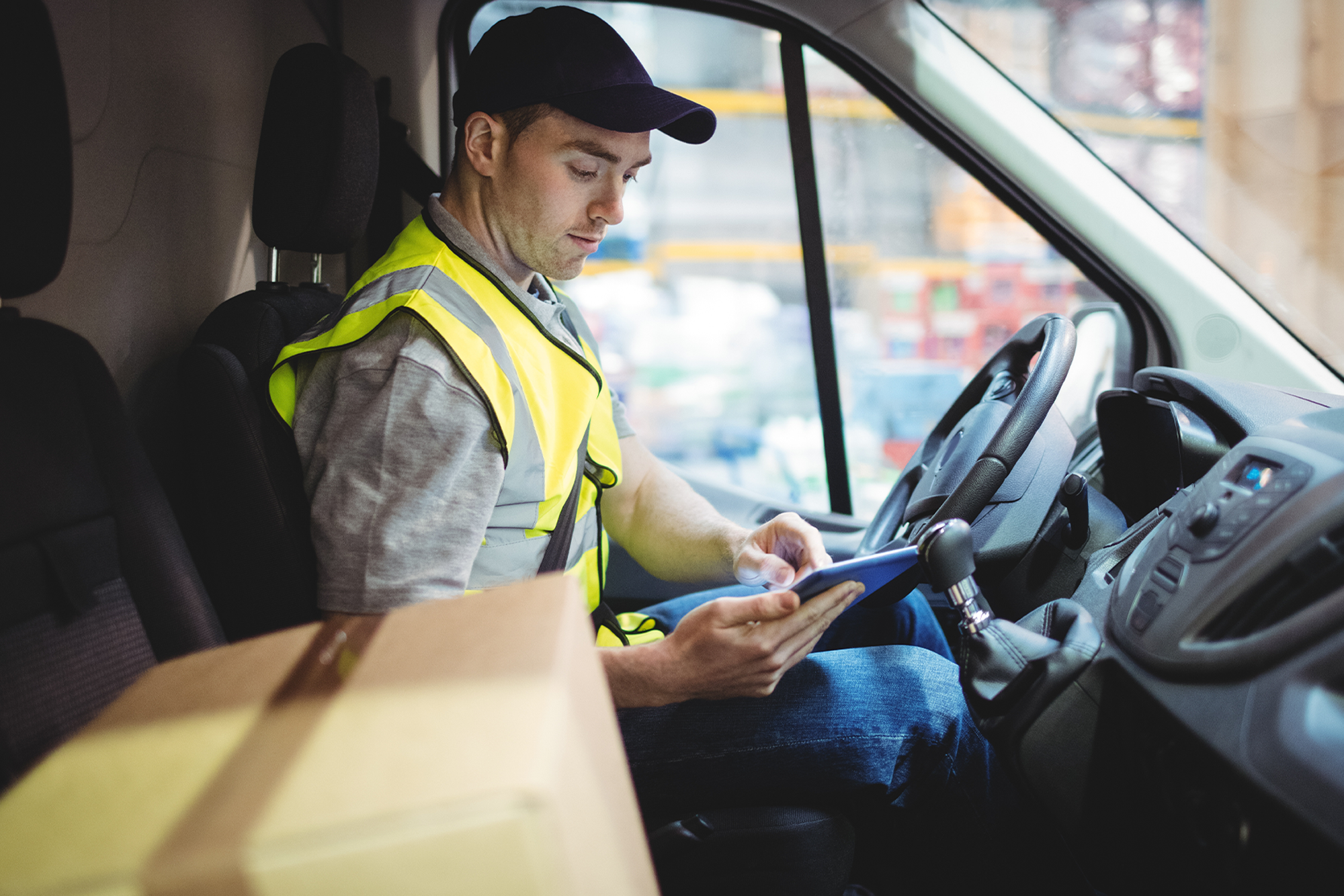 Steps for Businesses to Create Safer Drivers: A male driver sitting in his commercial vehicle going over a safety checklist.