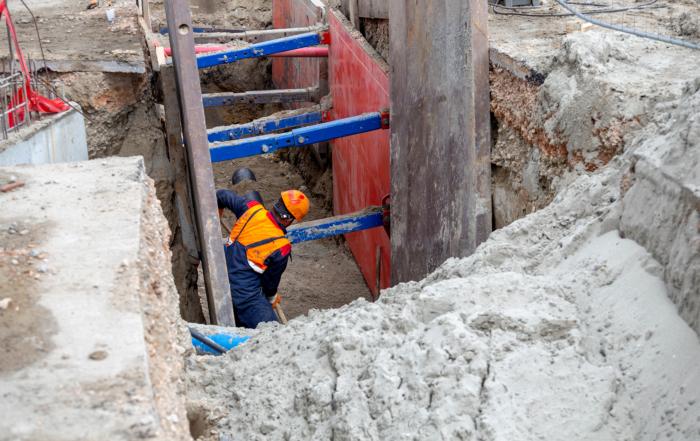 Trenching and Excavating Safety: A construction worker in a safely secured trench.
