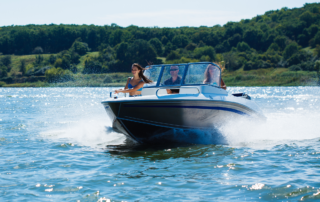 Insurance Coverage Basics For Boatowners: a boat on the open water with three occupants