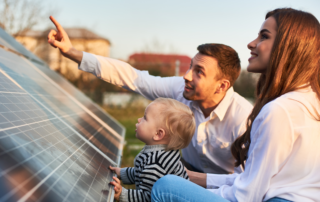 Solar Panel Installation Safety: A family of three looking at their newly installed solar panel.