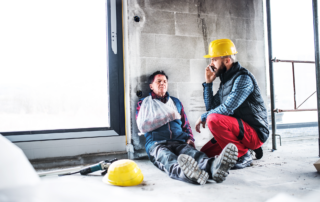 OSHA’s Safe and Sound Week Scheduled for Aug. 12-18: An injured contruction worker being tended to by a colleague