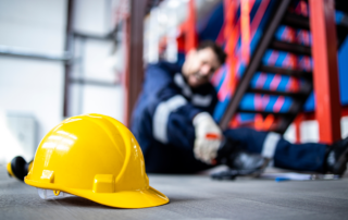 2024 Midyear Market Outlook: Workers' Compensation: An injured construction worker with a hard had in the foreground.