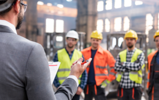 Best Practices for Safety Committees: A group of construction workers engaging in a safety meeting.