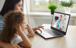 Healthy mother and child enjoying digital era, having online telemedicine consultation with remote doctor or watching educational video by professional paediatrician about cold and flu virus treatment